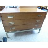 A modern teak finished three drawer dressing chest,