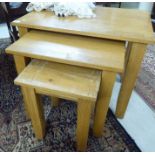 A nesting set of three modern light oak occasional tables,