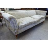 A modern 'Recline & Sprawl' three seater settee, upholstered in biscuit coloured,