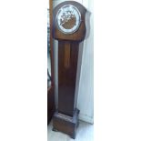 A 1930s oak cased granddaughter clock; the 8 day Westminster chime movement,