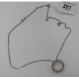 A 9ct white gold circular pendant, set with twenty small diamonds,