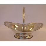 An Edwardian silver oval sweet basket with an engraved, pierced foliate,