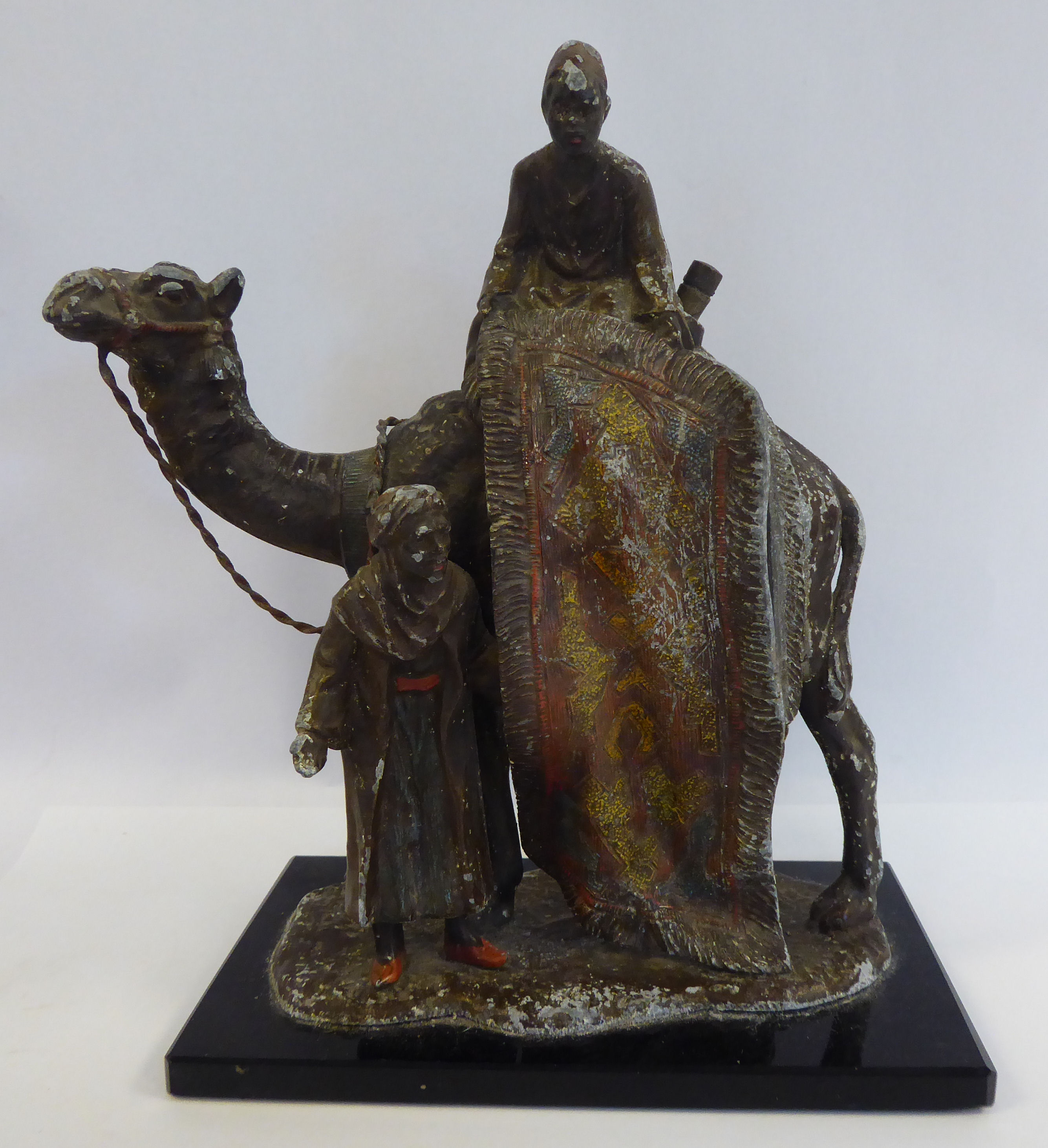 A 1920s painted spelter novelty table lighter, fashioned as two Arab carpet sellers,