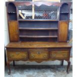 A late 18thC honey coloured oak dresser with crossbanded mahogany and fan marquetry ornament,