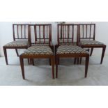 A set of six Edwardian mahogany framed dining chairs with square, vertically railed backs,