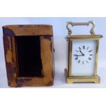 A mid 20thC lacquered brass cased carriage timepiece with bevelled glass panels and a folding top