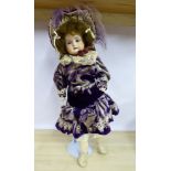 An early 20thC Armand Marseille bisque head doll with painted features and weighted sleeping eyes,