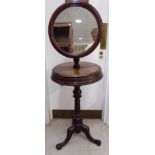 A late Victorian mahogany shaving stand, the fully adjustable 18''dia mirror set on a drum-top base,