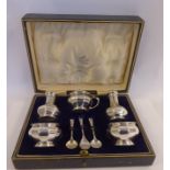 A five piece silver condiments set of bulbous dodecahedral form, comprising a pair of pepper pots,