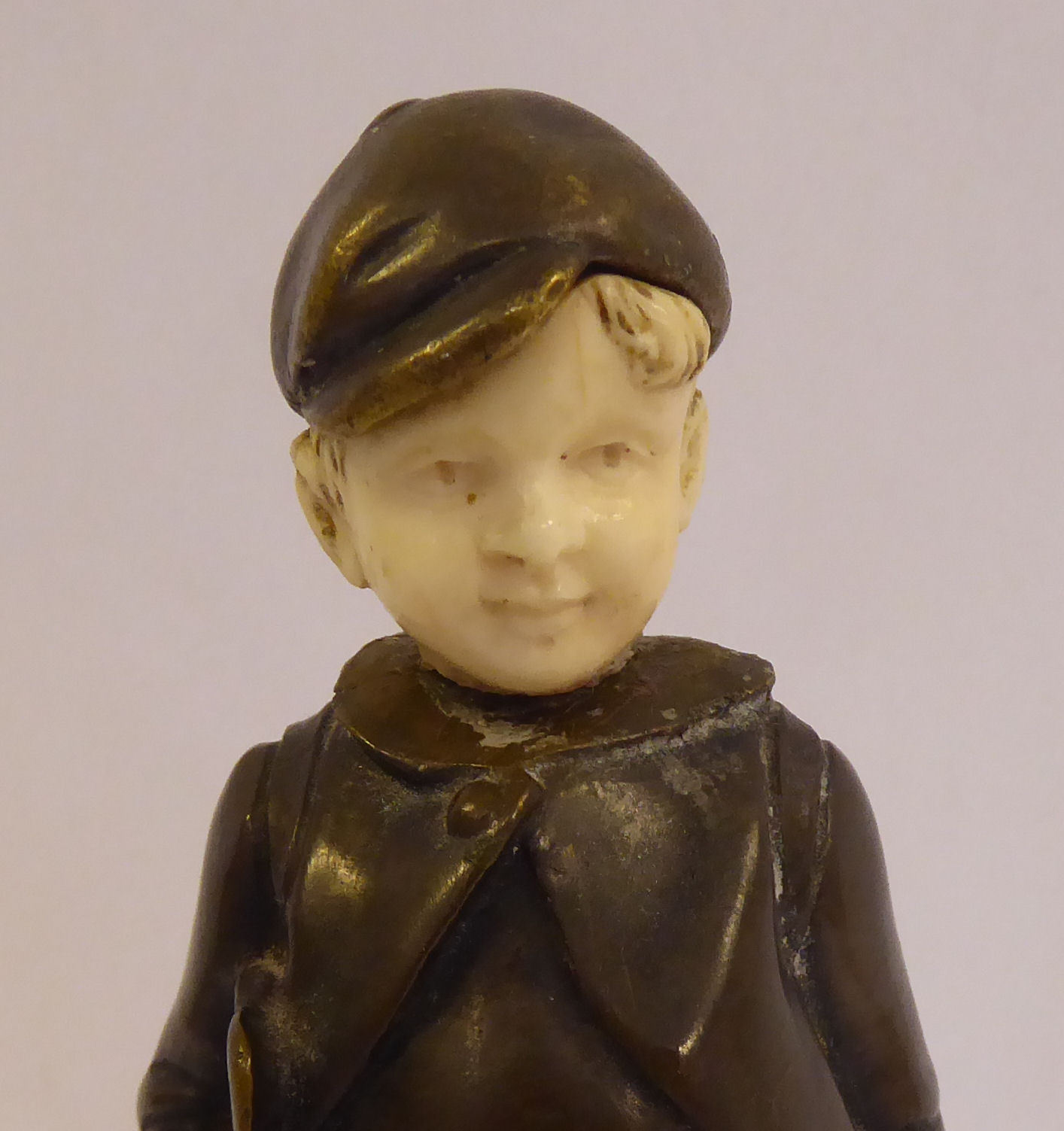 An early 20thC cast and patinated bronze and carved ivory figure, a Dutch boy, wearing a cap, - Image 5 of 5