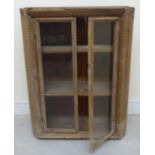 An unpainted pine 'Tramp Art' hanging cupboard,