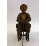A late 19thC painted cold cast bronze figure, a bewhiskered gentleman, wearing a to hat and bow tie,