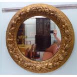 A Victorian style mirror, set in a carved fruit and foliate,