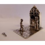 A late 19thC Dutch white metal miniature model 'Punch & Judy' with two standing spectators,