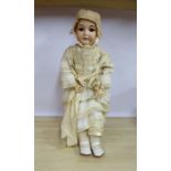 An early 20thC Bergmann bisque head doll with painted features and weighted sleeping eyes,