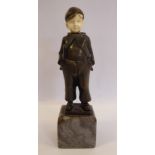 An early 20thC cast and patinated bronze and carved ivory figure, a Dutch boy, wearing a cap,