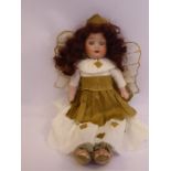 An early 20thC bisque head doll with painted features and fixed eyes,