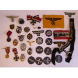 An uncollated collection of German (mainly World War II) related cap badges, other insignia,