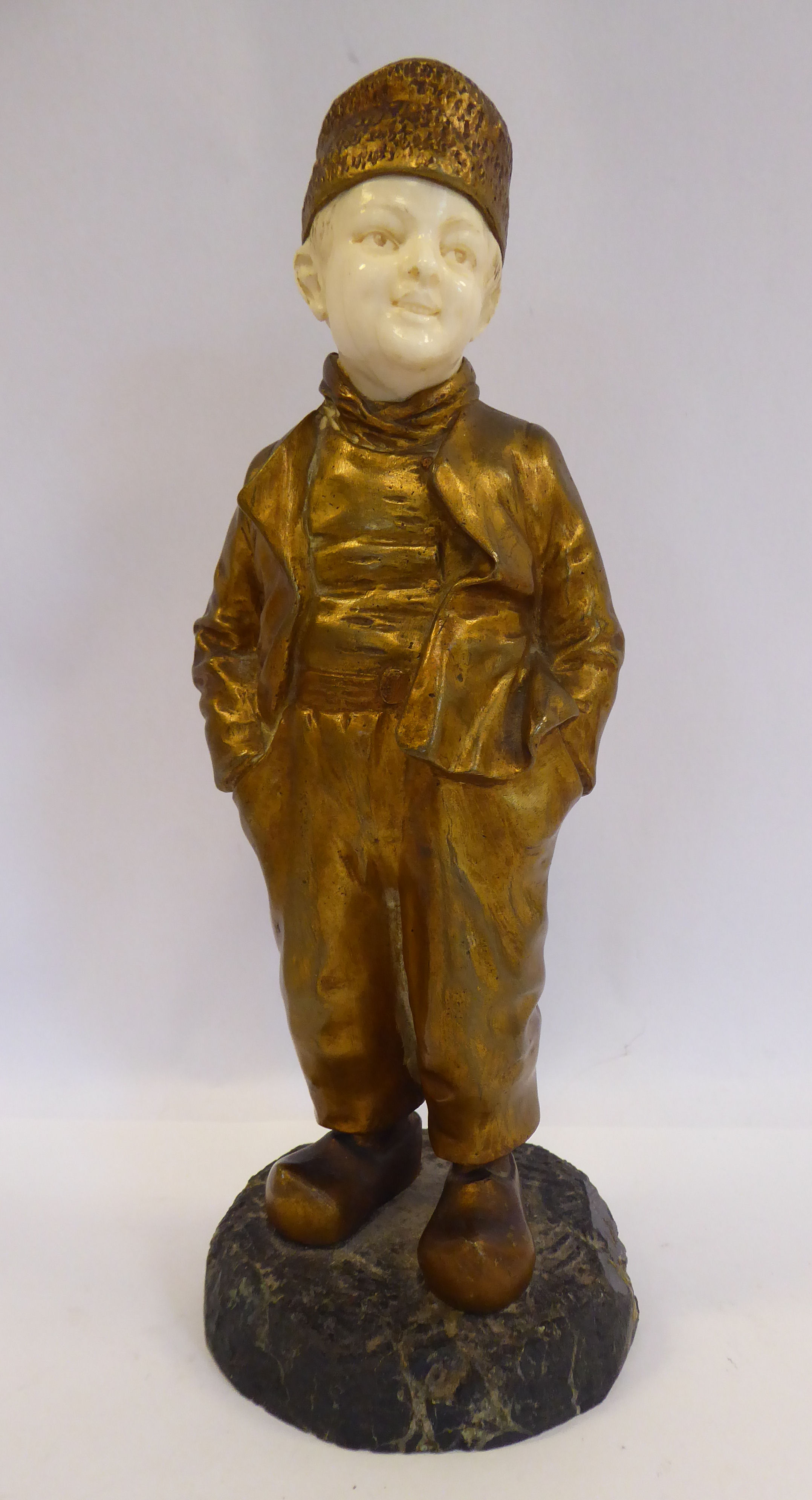 Joseph d'Aste - 'Jeune Homme' a cast gilt bronze and carved ivory standing figure,