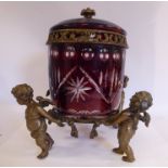 A mid 20thC Continental ruby coloured slice and star cut glass and cast brass biscuit box of drum