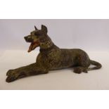 An early 20thC painted cold cast bronze model, a seated dog (possibly a Doberman),