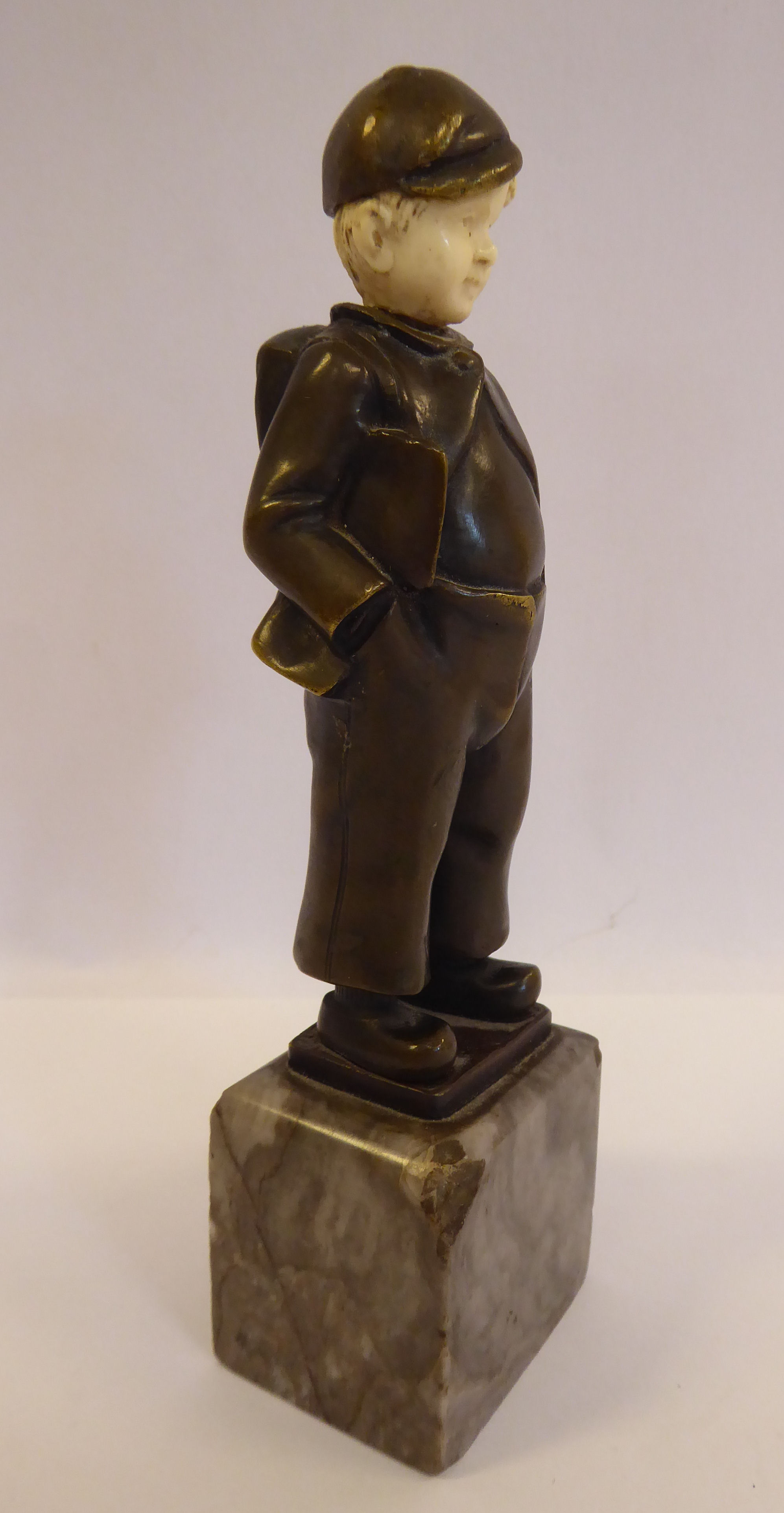 An early 20thC cast and patinated bronze and carved ivory figure, a Dutch boy, wearing a cap, - Image 3 of 5