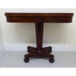 An early Victorian mahogany card table, the rotating, flame veneered,