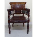 A late 19th/early 20thC mahogany framed desk chair with a round, high back and level arms,