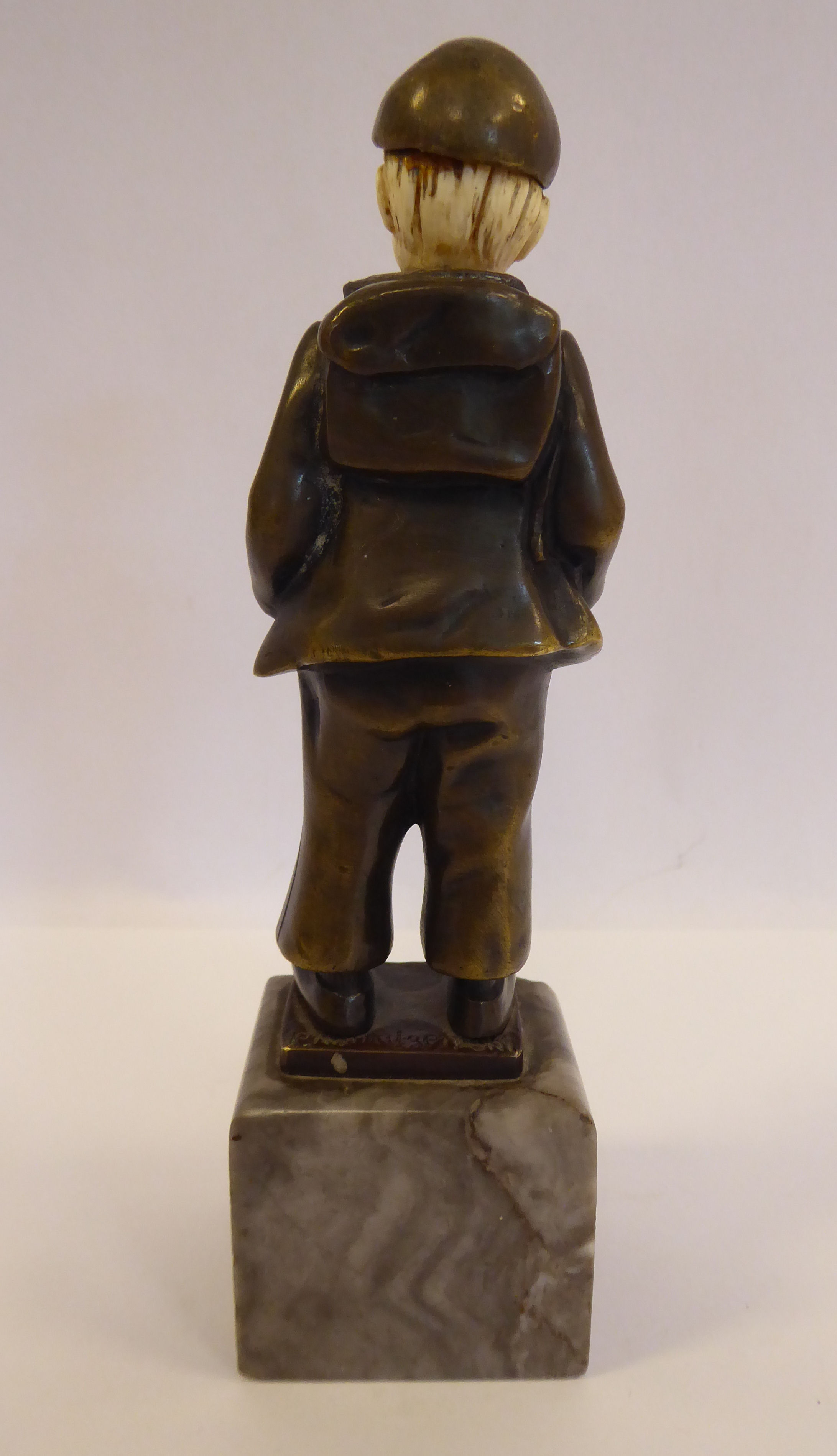 An early 20thC cast and patinated bronze and carved ivory figure, a Dutch boy, wearing a cap, - Image 4 of 5