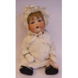 An early 20thC Armand Marseille bisque head doll with painted features and weighted sleeping eyes,