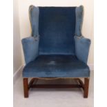 An early 19thC mahogany framed, upholstered wingback chair, having level,