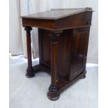 A mid Victorian rosewood Davenport, the top with a pierced,