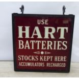 A mid 20thC black painted iron framed and glazed hanging box design, illuminated advertising sign,