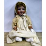 An early 20thC Simon & Halbig bisque head doll with painted features and weighted sleeping eyes,