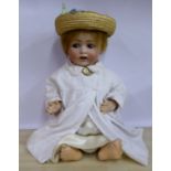 An early 20thC JDK bisque head doll with painted features and weighted sleeping eyes,