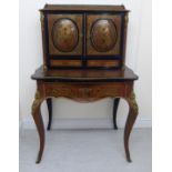 A late 19thC French Louis XV style, black lacquered, red boulle and ormolu mounted,