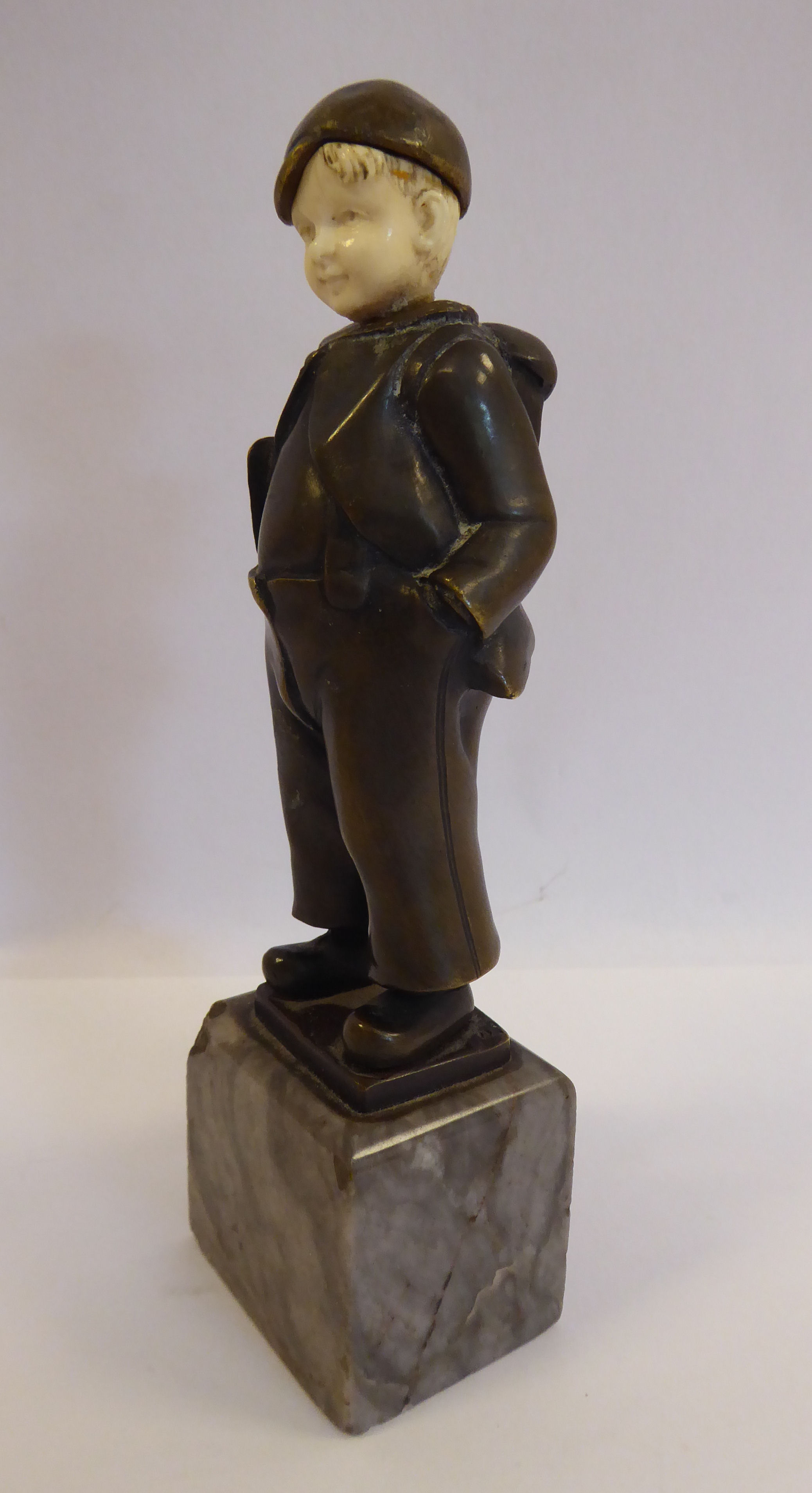 An early 20thC cast and patinated bronze and carved ivory figure, a Dutch boy, wearing a cap, - Image 2 of 5