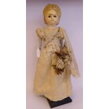 A late 19thC wax covered papier mache head doll,