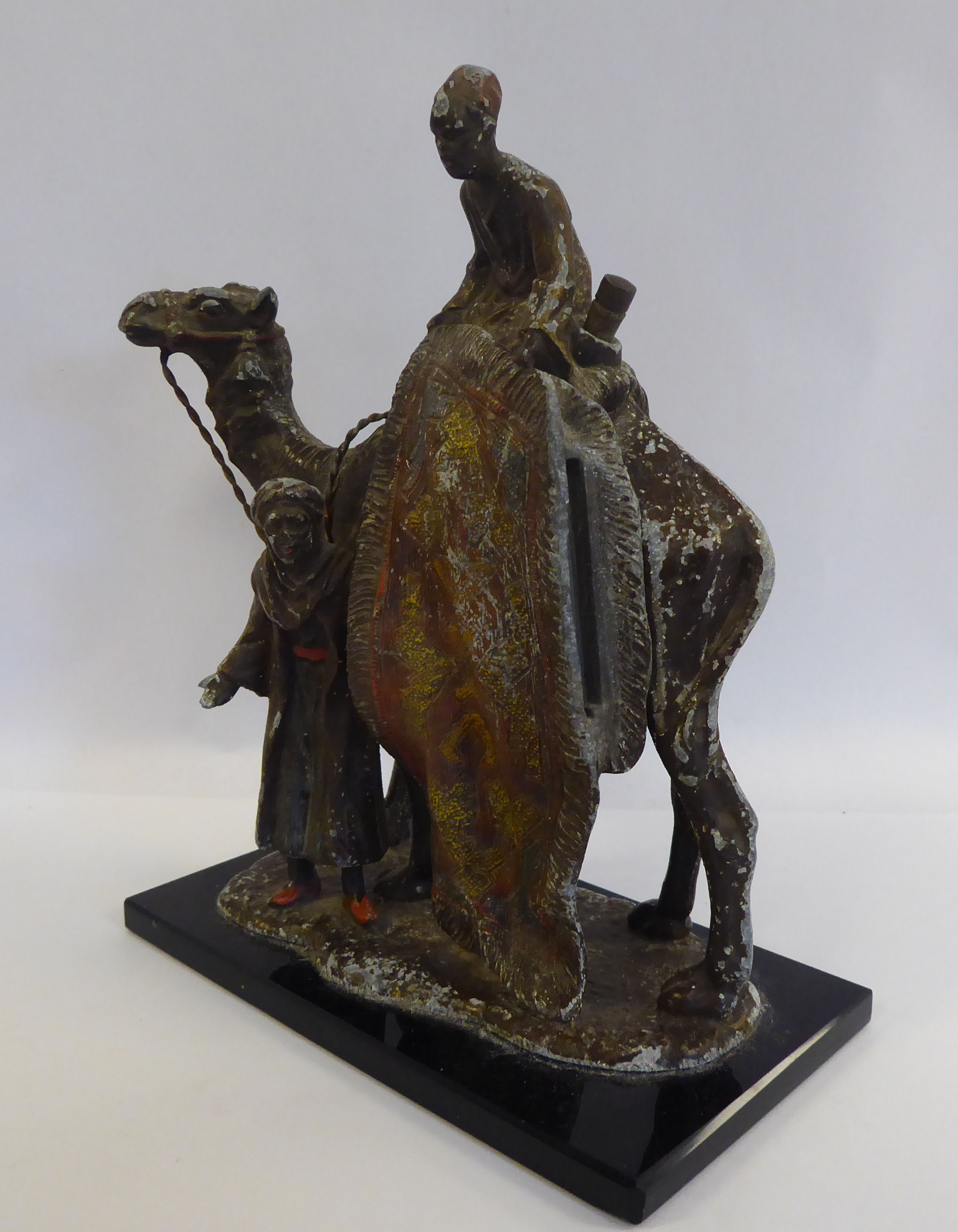 A 1920s painted spelter novelty table lighter, fashioned as two Arab carpet sellers, - Image 6 of 7