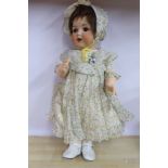 An early 20thC Armand Marseille bisque head doll with painted features and weighted sleeping eyes,