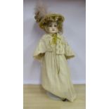 A late 19thC wax head doll with fixed glass eyes,