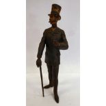 A late 19thC painted cold cast bronze figure, a standing gentleman, wearing a top hat and coat,