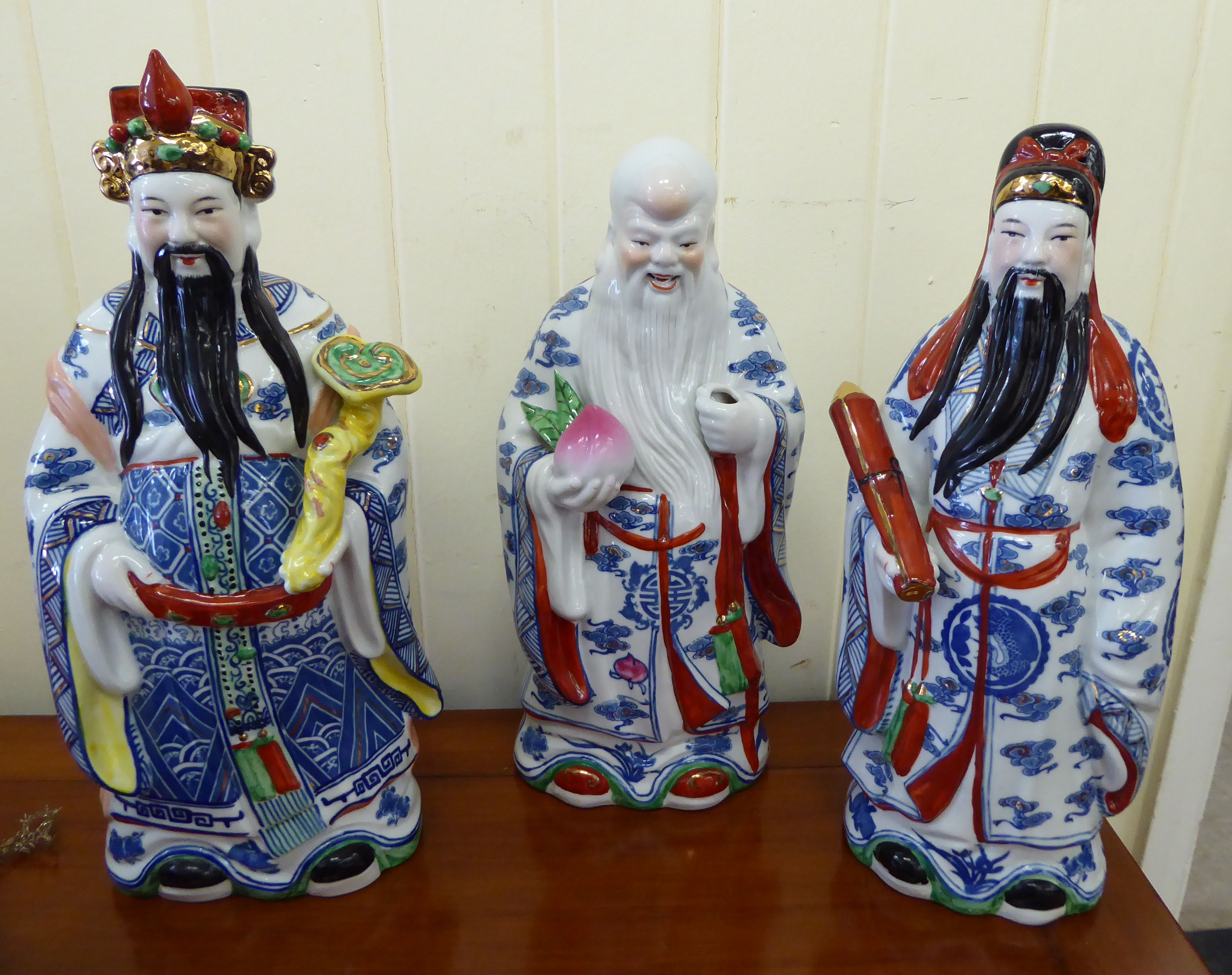 Three modern Chinese ceramic figures, each representing an elder, wearing traditional robes 13.