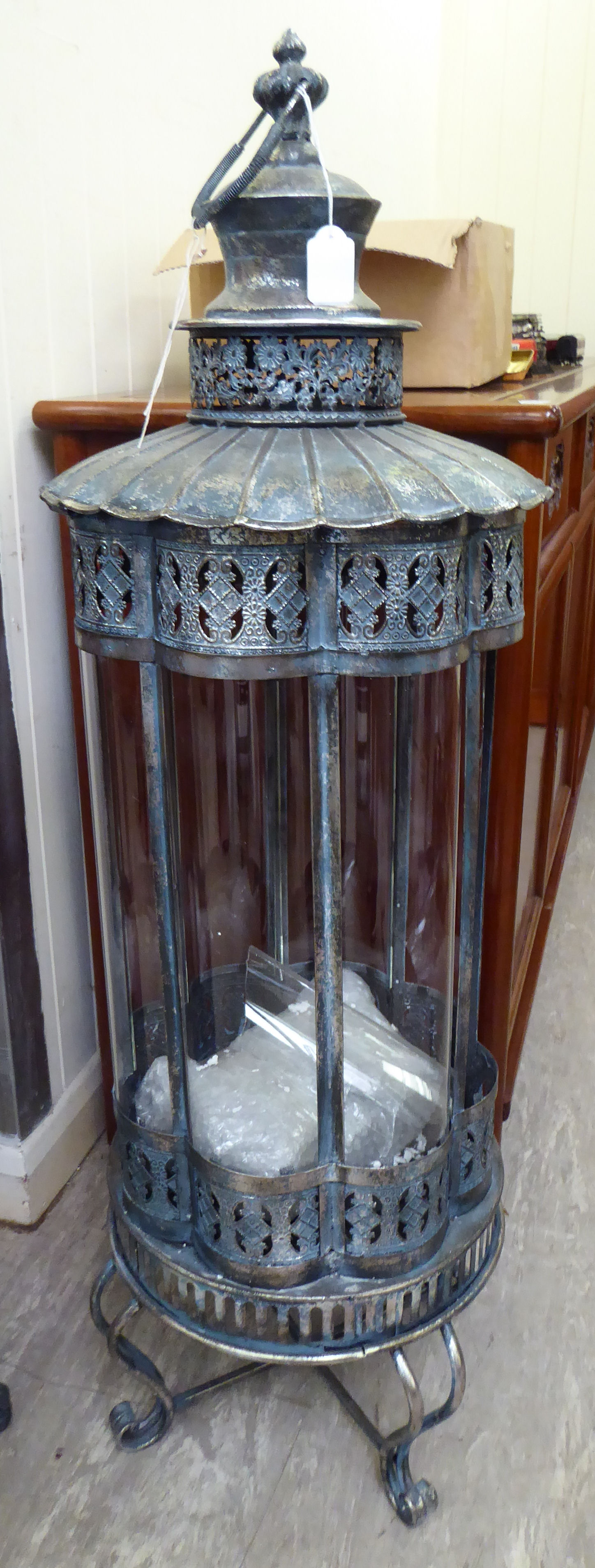 An as new, blue and silver painted metal floorstanding garden lantern with curved glass panels,