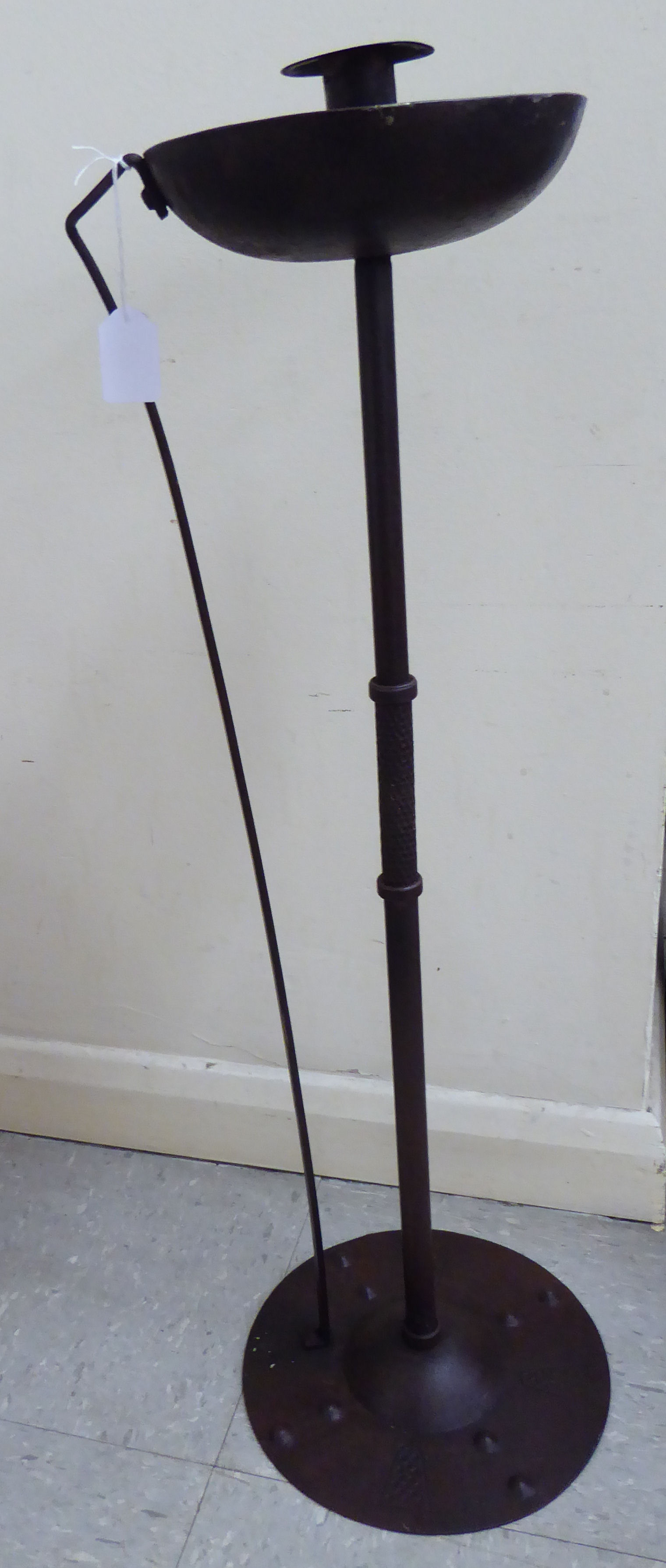 An Arts & Crafts inspired lacquered iron candlestand,