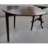 A George III stained oak drop leaf table, raised on square,