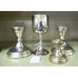 A pair of loaded silver dwarf candlesticks with cast Celtic ornament around the sockets 4.