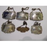 Three dissimilar 19thC silver wine labels, on chains; and a matched set of three more,