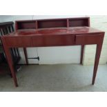 A modern red laminated bureau with an open compartment upstand, over three frieze drawers,