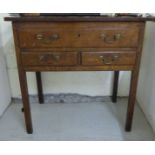 A George III oak lowboy with one long/two short drawers, raised on square legs 29.